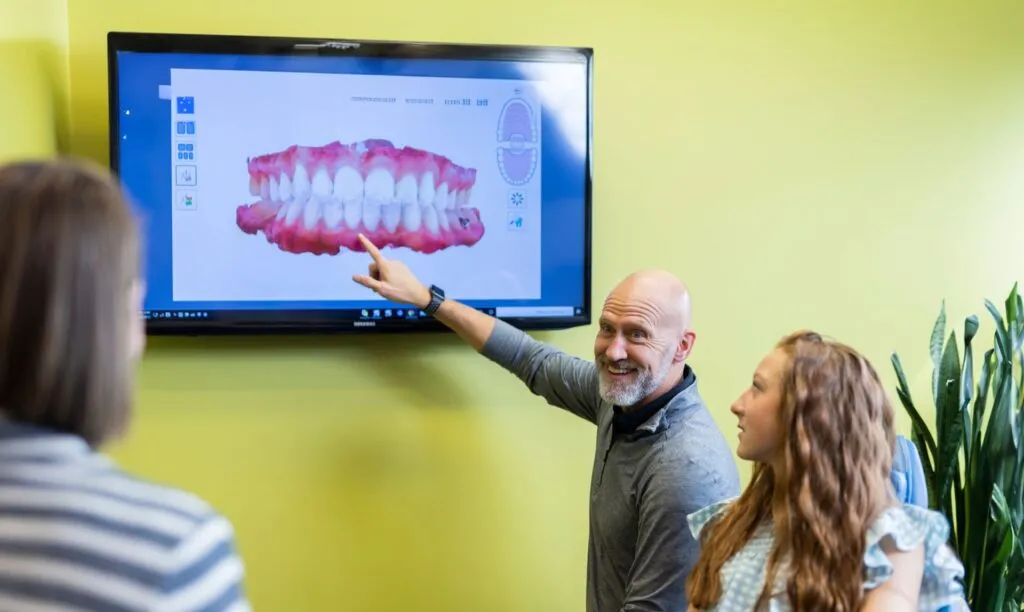 Orthodontist showing patient scan of her teeth