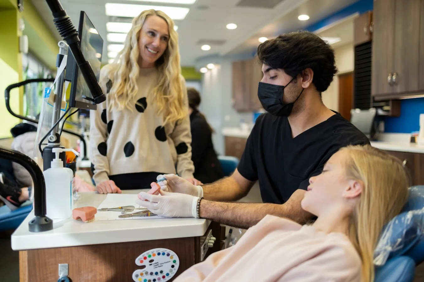 Team member discussing treatment with young patient