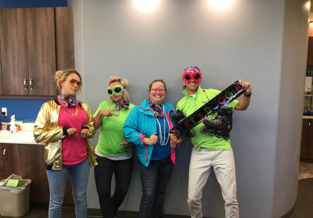Team members dressed up in bright outfits